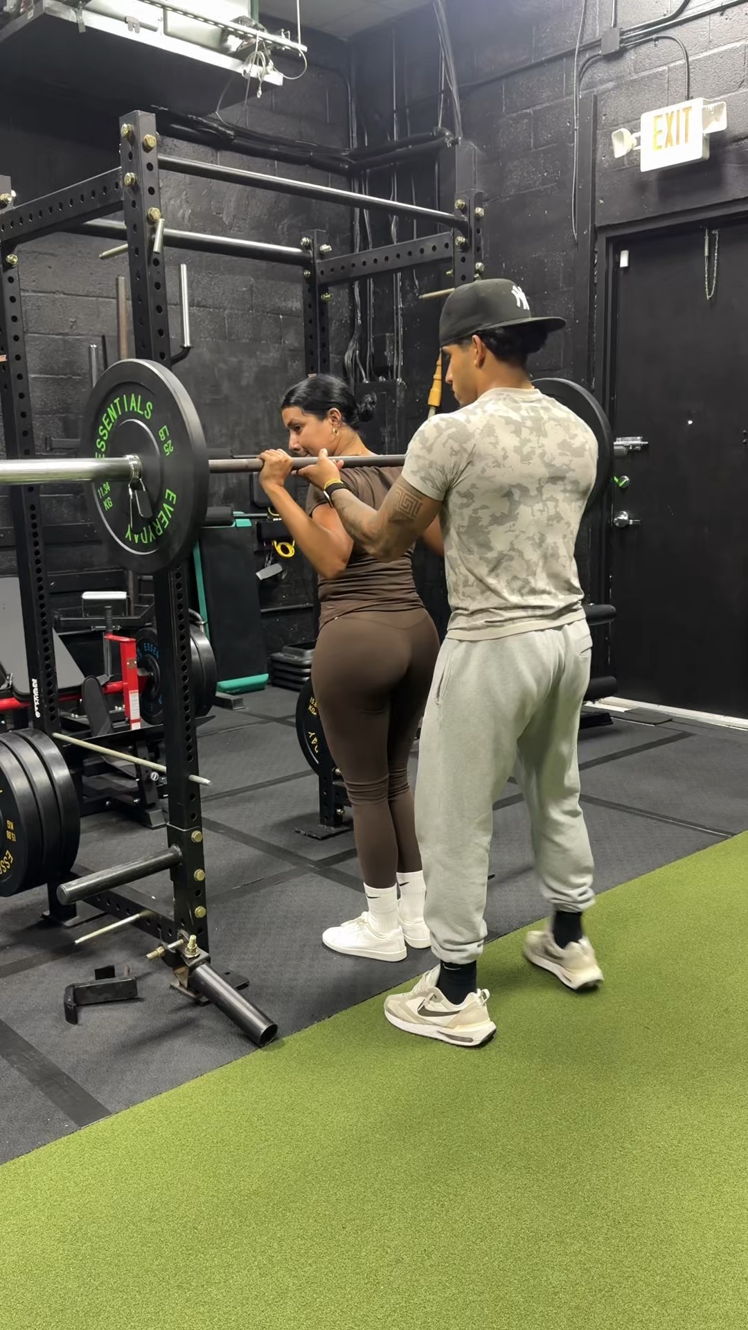 Johnny coaching a barbell squat